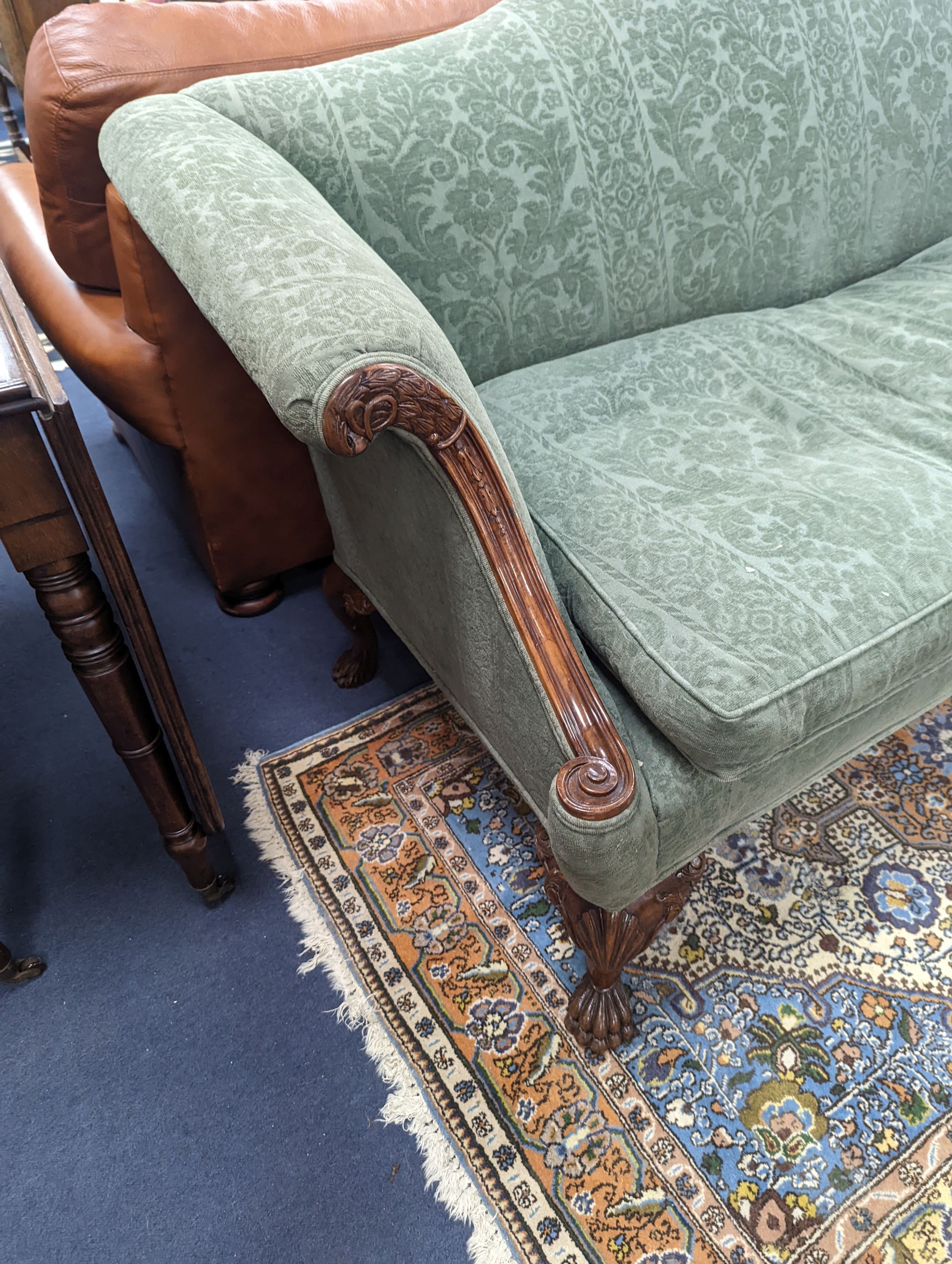 A George I style upholstered carved walnut settee on shell carved cabriole claw feet, length 220cm, depth 80cm, height 94cm